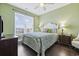 This primary bedroom features a large window for great natural light and wood flooring at 730 Pickering Dr. # 201, Murrells Inlet, SC 29576