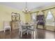 Elegant dining room with hardwood floors, chandelier, and ample natural light at 730 Pickering Dr. # 201, Murrells Inlet, SC 29576