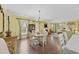 Formal dining area boasts hardwood floors, a chandelier, and bright windows with decorative curtains at 730 Pickering Dr. # 201, Murrells Inlet, SC 29576