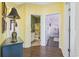 View of hallway leading to bathroom and another room with wood flooring and neutral colored walls at 730 Pickering Dr. # 201, Murrells Inlet, SC 29576