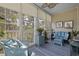 Relaxing sunroom with comfortable wicker seating, ceiling fan, and bright natural light at 730 Pickering Dr. # 201, Murrells Inlet, SC 29576