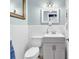 Charming bathroom featuring a grey vanity with white tiled walls and a framed mirror at 7714 Woodland Dr., Myrtle Beach, SC 29572