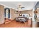 Stylish bedroom featuring a brick accent wall, hardwood floors, and modern furnishings at 7714 Woodland Dr., Myrtle Beach, SC 29572