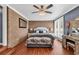 Comfortable bedroom featuring a brick accent wall, ceiling fan, and stylish decor at 7714 Woodland Dr., Myrtle Beach, SC 29572