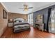 Well-lit bedroom with brick wall, ceiling fan, and modern decor, complemented by natural light at 7714 Woodland Dr., Myrtle Beach, SC 29572