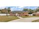 Charming brick home featuring a well-manicured lawn and a classic, welcoming facade at 7714 Woodland Dr., Myrtle Beach, SC 29572