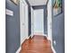Hallway with wood flooring, white trim, and neutral wall paint at 7714 Woodland Dr., Myrtle Beach, SC 29572