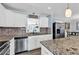 Modern kitchen with granite countertops, stainless steel appliances, and ample cabinet space at 7714 Woodland Dr., Myrtle Beach, SC 29572