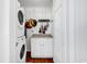 Functional laundry area with stacked washer/dryer and charming decorative elements at 7714 Woodland Dr., Myrtle Beach, SC 29572
