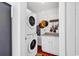 Well-organized laundry room with stacked washer/dryer and white cabinets for storage at 7714 Woodland Dr., Myrtle Beach, SC 29572