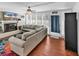 Cozy living room with fireplace, modern ceiling fan, wood plank flooring and lots of natural light at 7714 Woodland Dr., Myrtle Beach, SC 29572