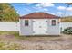 Well-maintained storage shed with double doors, windows, and a tidy exterior at 7714 Woodland Dr., Myrtle Beach, SC 29572