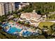 Aerial view of a resort featuring multiple pools, lush landscaping, and an elegant building at 8053 Laurel Ash Ave., Myrtle Beach, SC 29572