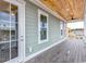 Covered balcony showcasing wood ceiling, ceiling fans, outdoor living space, and views at 8053 Laurel Ash Ave., Myrtle Beach, SC 29572
