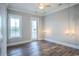 Bright bedroom featuring hardwood floors, ceiling fan, and chandeliers at 8053 Laurel Ash Ave., Myrtle Beach, SC 29572