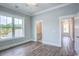 Light-filled bedroom features hardwood floors and large window overlooking a wooded yard at 8053 Laurel Ash Ave., Myrtle Beach, SC 29572