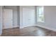 Bedroom featuring wood floors, a double closet, and a bright window at 8053 Laurel Ash Ave., Myrtle Beach, SC 29572