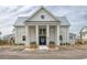 Attractive clubhouse exterior with a symmetrical facade, white columns, and a welcoming entrance at 8053 Laurel Ash Ave., Myrtle Beach, SC 29572
