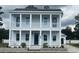 Stunning two-story home with double balconies, columns, and neatly landscaped yard exudes Southern charm at 8053 Laurel Ash Ave., Myrtle Beach, SC 29572