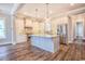 Modern kitchen featuring an island, stainless steel appliances, white cabinetry, and hardwood floors at 8053 Laurel Ash Ave., Myrtle Beach, SC 29572