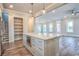 Bright kitchen showcasing island with seating, stainless appliances, ample storage, and views of the living room at 8053 Laurel Ash Ave., Myrtle Beach, SC 29572