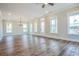 Open-concept living area features hardwood floors, modern lighting, and multiple windows for ample natural light at 8053 Laurel Ash Ave., Myrtle Beach, SC 29572