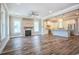 Expansive living room features a fireplace, modern lighting, and opens to a spacious kitchen with modern appliances at 8053 Laurel Ash Ave., Myrtle Beach, SC 29572