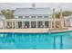 Community pool with clubhouse, lounge seating, and palm trees at 8053 Laurel Ash Ave., Myrtle Beach, SC 29572