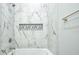 Shower featuring marble tiled walls, a built in shower niche, and brushed nickel hardware at 8053 Laurel Ash Ave., Myrtle Beach, SC 29572