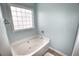 Bathroom featuring a pristine soaking tub with textured window for natural light at 807 Lalton Dr., Conway, SC 29526