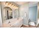 Bathroom featuring double vanity, framed mirrors, stylish fixtures, and white shaggy rug at 807 Lalton Dr., Conway, SC 29526