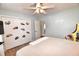 Bedroom featuring a ceiling fan, cartoon stickers, and ample closet space at 807 Lalton Dr., Conway, SC 29526