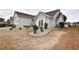 Well-maintained home exterior with landscaped beds, manicured bushes, and a side entry garage at 807 Lalton Dr., Conway, SC 29526