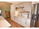 Bright kitchen with stainless steel refrigerator, white cabinets and countertops, and wood-look flooring at 807 Lalton Dr., Conway, SC 29526