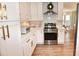 Modern kitchen features white cabinets, stainless steel appliances, and a wreath above the stove at 807 Lalton Dr., Conway, SC 29526