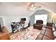 Upstairs office area features a ceiling fan, a leather couch, a desk and a mini refrigerator at 807 Lalton Dr., Conway, SC 29526
