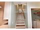 Bright staircase with light walls and wood handrail leads to the upper level and kitchen access at 807 Lalton Dr., Conway, SC 29526