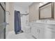 Clean bathroom with a shower-tub combo, white vanity, and decorative mirror at 823 Waterton Ave., Myrtle Beach, SC 29579