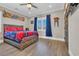 The bedroom has a wooden bedframe, sports decor, and a ceiling fan at 823 Waterton Ave., Myrtle Beach, SC 29579