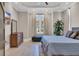 Primary bedroom with tray ceilings, dresser, tile floors, and ample light at 823 Waterton Ave., Myrtle Beach, SC 29579