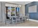 Bright dining room with chandelier, table with seating for six, and large windows overlooking the property at 823 Waterton Ave., Myrtle Beach, SC 29579