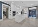 Spacious white kitchen with a central island, stainless steel appliances, tile backsplash, and modern pendant lighting at 823 Waterton Ave., Myrtle Beach, SC 29579