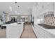 Open-concept kitchen with stainless steel appliances, a center island, and view of the living and dining areas at 823 Waterton Ave., Myrtle Beach, SC 29579