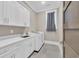Laundry room with modern washer, dryer, white cabinets, and sink at 823 Waterton Ave., Myrtle Beach, SC 29579