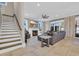 Cozy living room featuring a fireplace, large windows, comfortable seating, and access to a staircase at 823 Waterton Ave., Myrtle Beach, SC 29579