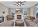 Comfortable living room with a fireplace, large windows, soft lighting, and plush seating for a relaxing atmosphere at 823 Waterton Ave., Myrtle Beach, SC 29579
