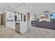 Open-concept living space featuring a kitchen island, staircase, and a comfortable seating area with a fireplace and TV at 823 Waterton Ave., Myrtle Beach, SC 29579