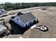 Aerial view of a modern home with a patio and fire pit, showcasing its lot and outdoor living space at 85 Northbrook Dr, Murrells Inlet, SC 29576