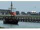 Charming water view of pirate ship sailing by the dock, with buildings in the background at 85 Northbrook Dr, Murrells Inlet, SC 29576