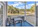 Back porch features a table and chairs looking out on a pond and trees at 881 Palmetto Trail # 103, Myrtle Beach, SC 29577